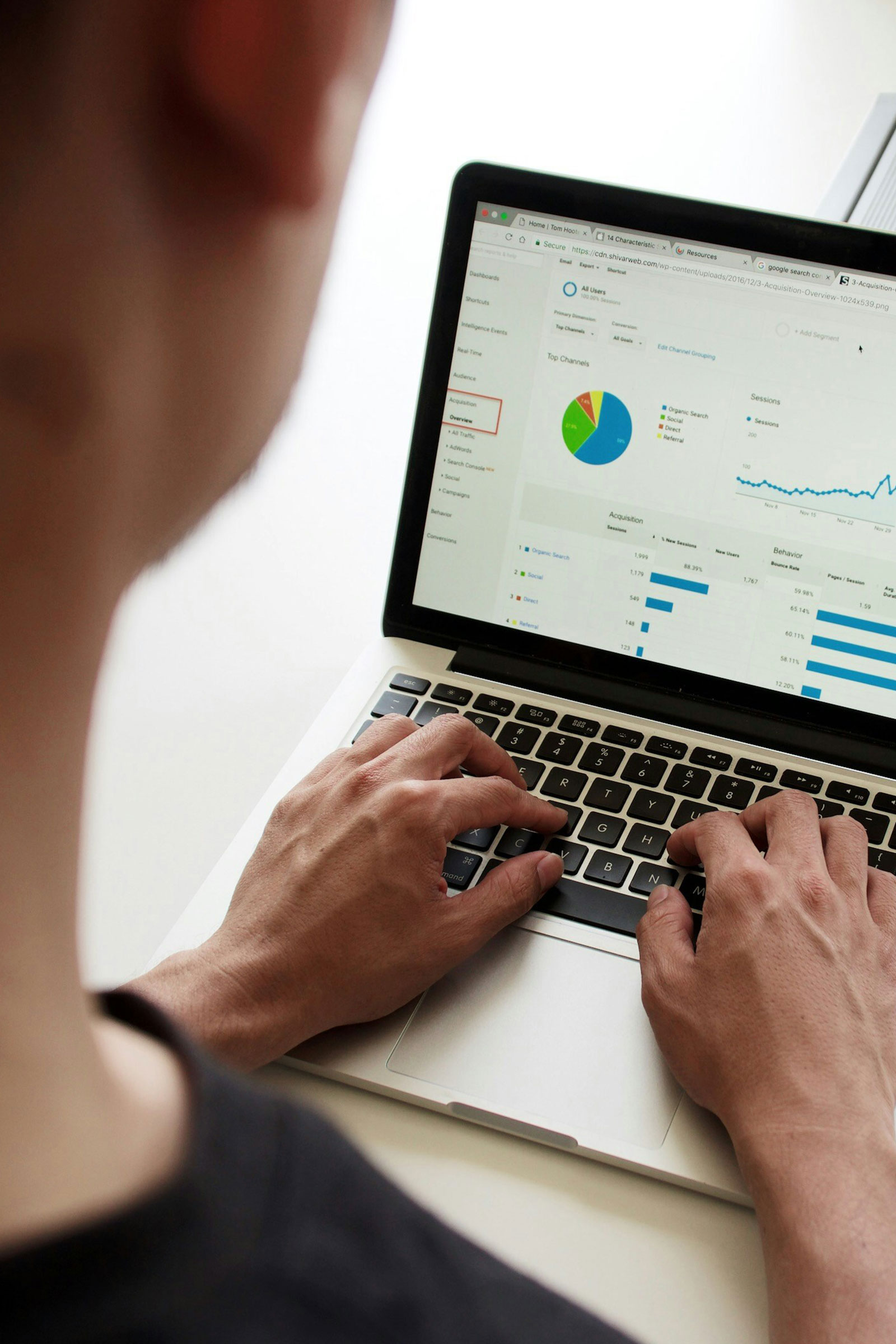 Person on a computer looking at cost charts and ROI scores